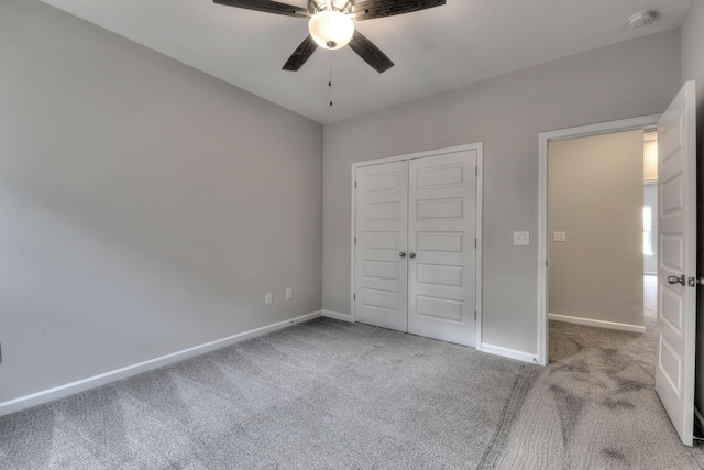 unfurnished bedroom with ceiling fan, a closet, and light carpet