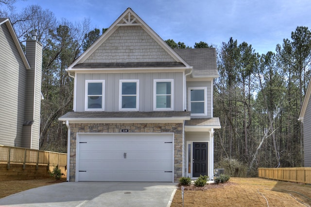 craftsman inspired home with cooling unit and a garage