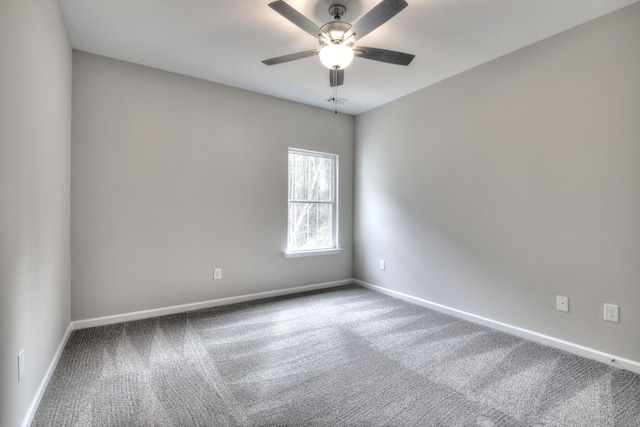 spare room with carpet and ceiling fan