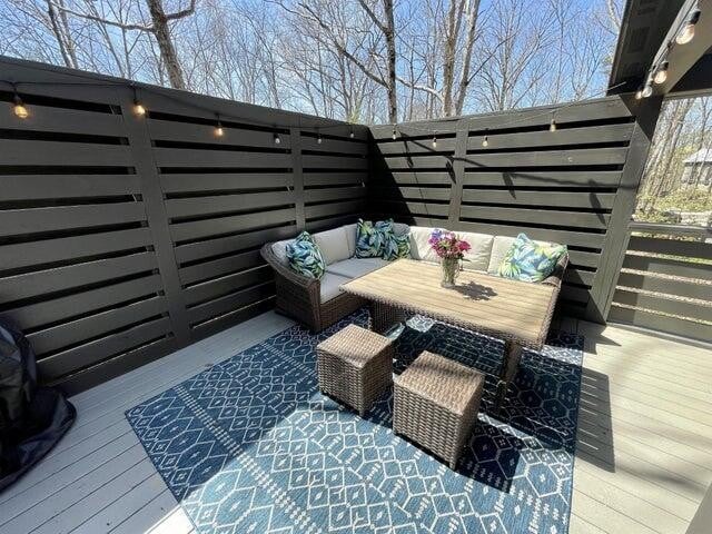 wooden terrace with an outdoor hangout area