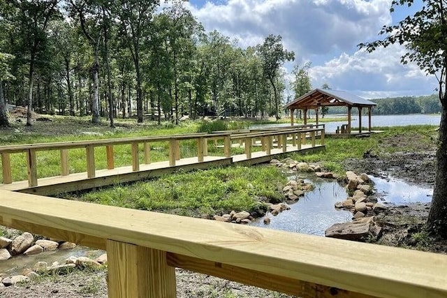 view of dock with a water view and a gazebo