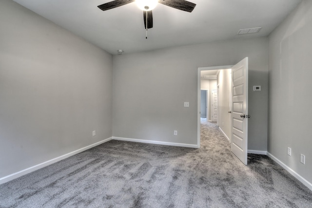 empty room featuring ceiling fan and carpet flooring