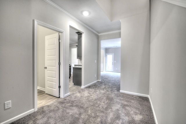 hall with crown molding and carpet