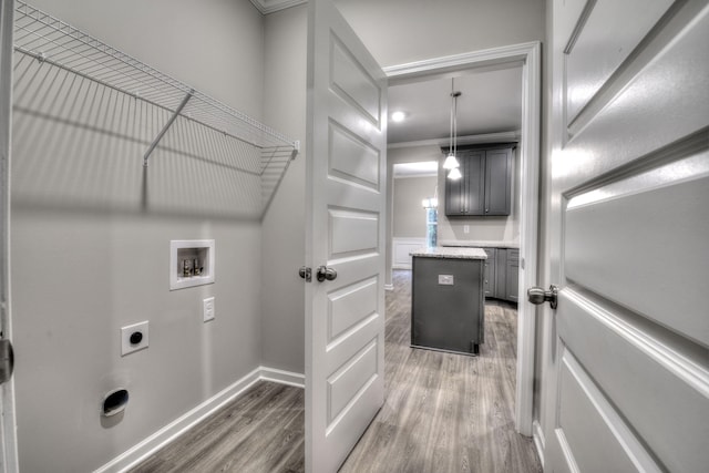 laundry area featuring ornamental molding, hookup for an electric dryer, hookup for a washing machine, and dark hardwood / wood-style flooring