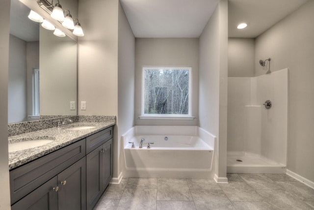 bathroom featuring shower with separate bathtub, tile patterned flooring, and vanity