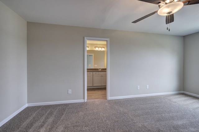 empty room with ceiling fan and light colored carpet