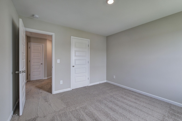 unfurnished bedroom with light carpet and a closet