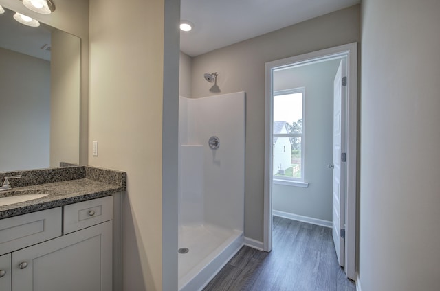 bathroom featuring a shower, vanity, and wood-type flooring