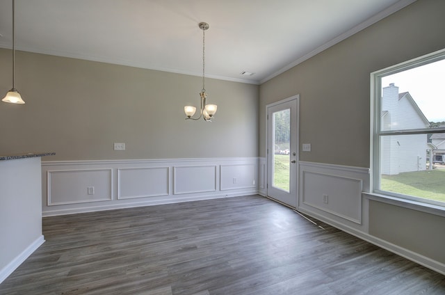 unfurnished dining area with a healthy amount of sunlight, crown molding, and dark hardwood / wood-style floors