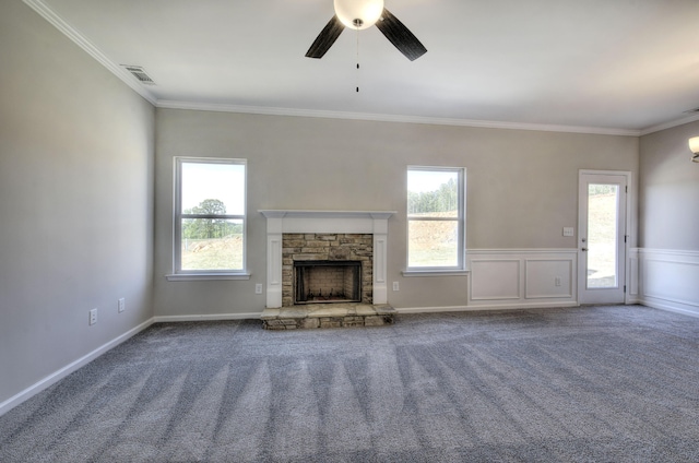 unfurnished living room featuring carpet floors, crown molding, a fireplace, and ceiling fan