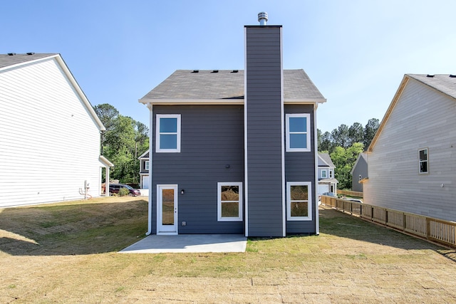 rear view of house with a yard and a patio