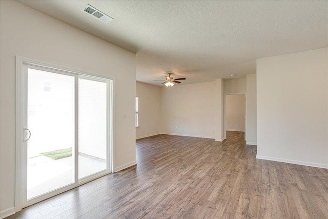 empty room featuring a textured ceiling, ceiling fan, and light hardwood / wood-style flooring