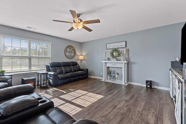 living room with ceiling fan and dark hardwood / wood-style flooring