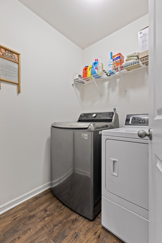 washroom featuring washer and clothes dryer and dark wood-type flooring