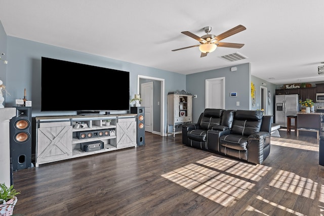 living room with ceiling fan and dark wood-type flooring