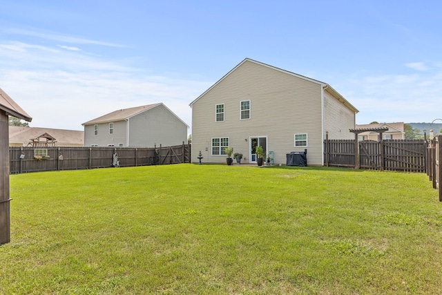 back of house featuring a yard