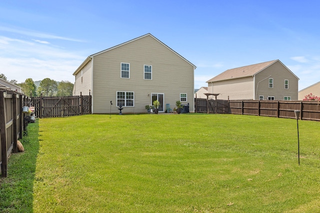 back of property featuring a lawn