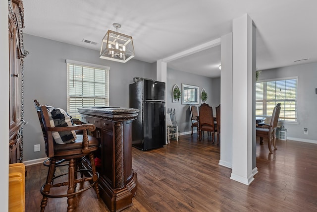 dining room with a chandelier and dark hardwood / wood-style flooring