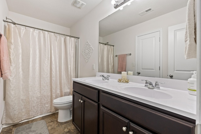 bathroom featuring a shower with curtain, vanity, and toilet