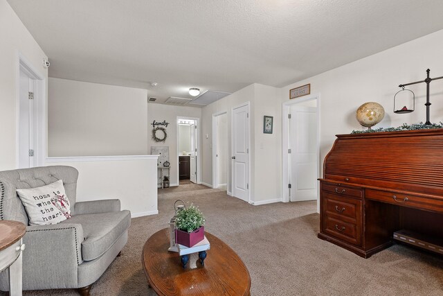 carpeted living room featuring a textured ceiling