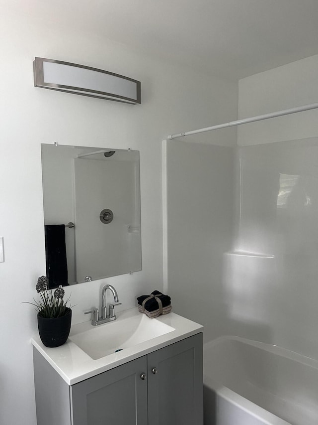 bathroom featuring shower / bathtub combination and vanity