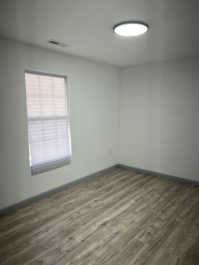 spare room featuring hardwood / wood-style floors