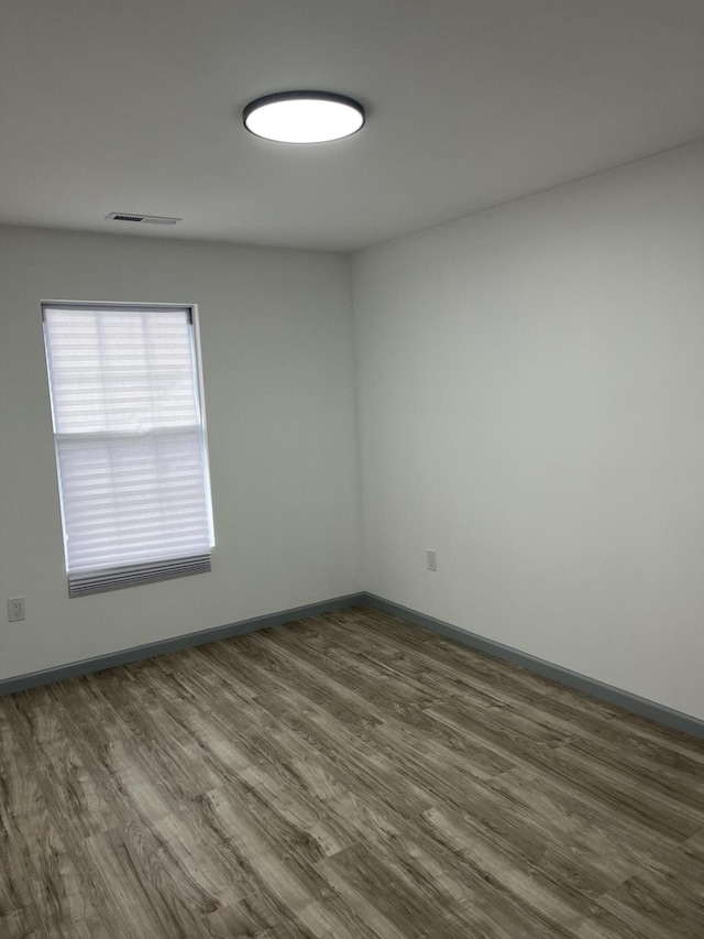 empty room featuring dark wood-type flooring