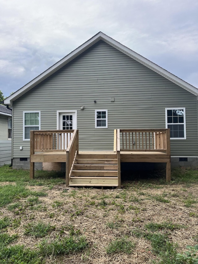 back of property featuring a wooden deck