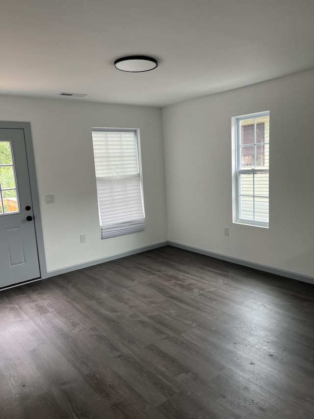 interior space featuring a wealth of natural light and dark hardwood / wood-style floors