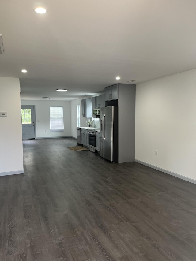 unfurnished living room featuring dark wood-type flooring