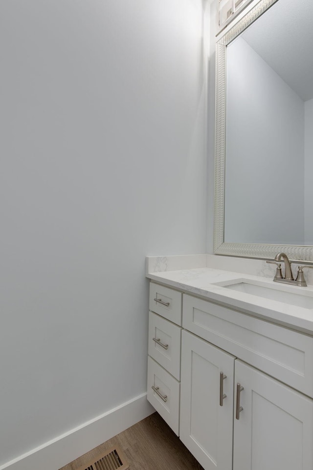 bathroom with vanity and hardwood / wood-style flooring