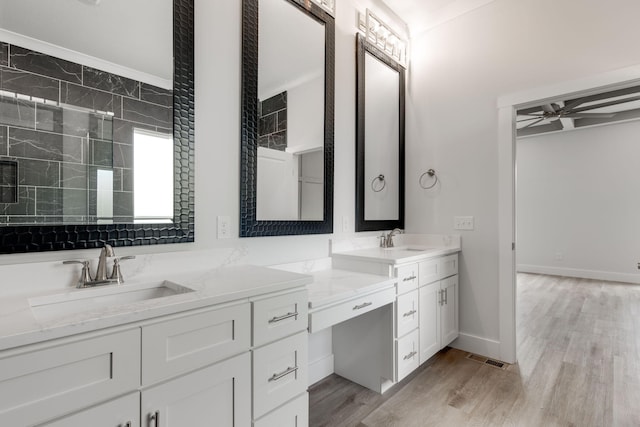 bathroom with ceiling fan, vanity, walk in shower, and hardwood / wood-style floors