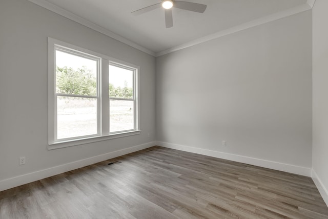 empty room featuring ornamental molding, ceiling fan, and hardwood / wood-style flooring