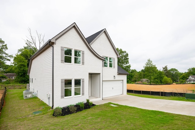 view of front of property with a front yard and a garage