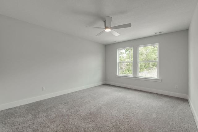 carpeted spare room with ceiling fan