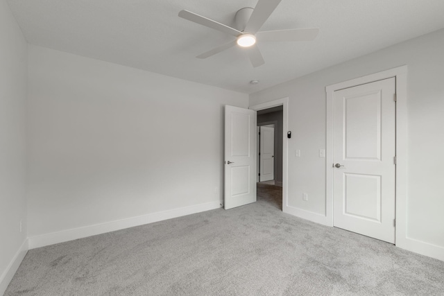 unfurnished bedroom featuring ceiling fan and light colored carpet