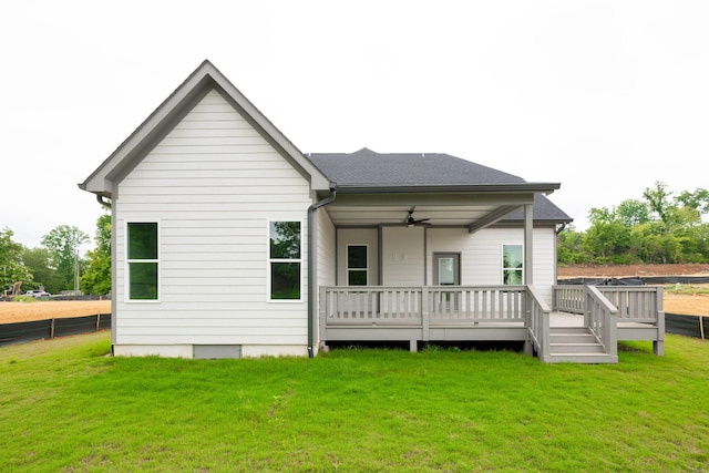 back of house featuring ceiling fan, a deck, and a yard