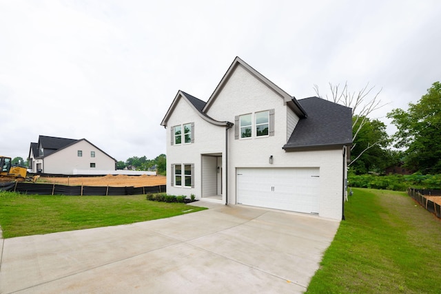 view of front of house with a garage and a front lawn