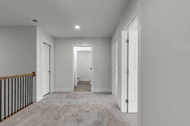 hallway with light colored carpet