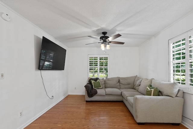 living room featuring ceiling fan, hardwood / wood-style flooring, and a wealth of natural light