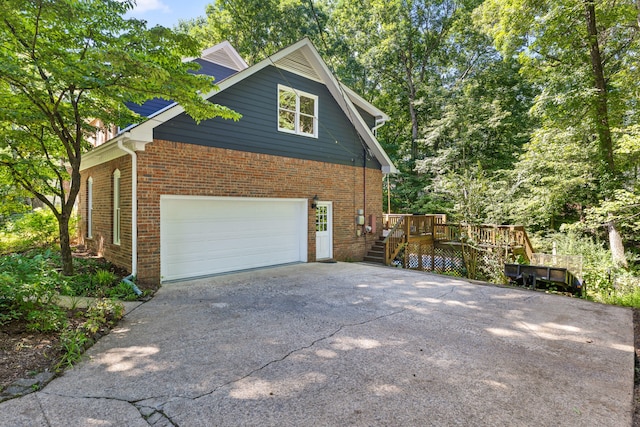 view of home's exterior featuring a garage and a wooden deck