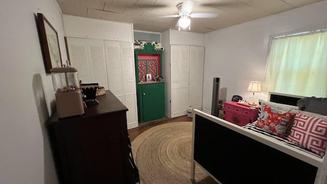 bedroom with ceiling fan and dark wood-type flooring