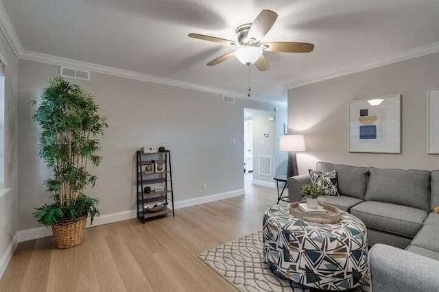 living room with crown molding, light hardwood / wood-style floors, and ceiling fan