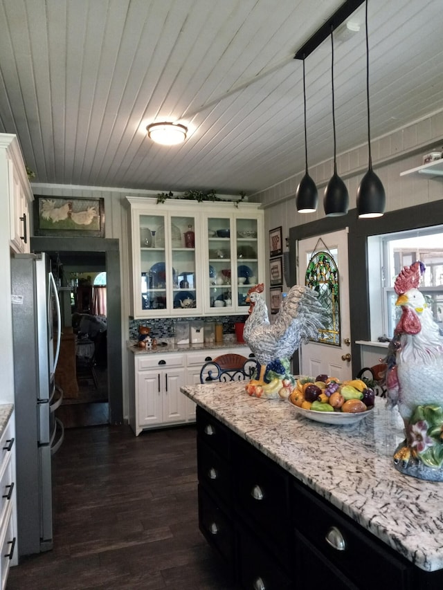 kitchen with wood ceiling, dark hardwood / wood-style floors, stainless steel fridge, pendant lighting, and white cabinetry