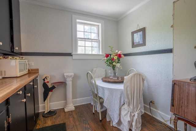 dining space with crown molding and dark hardwood / wood-style floors