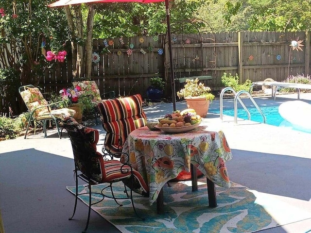 view of patio / terrace with a fenced in pool