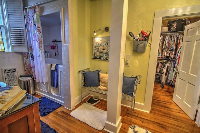 bathroom featuring hardwood / wood-style flooring and walk in shower