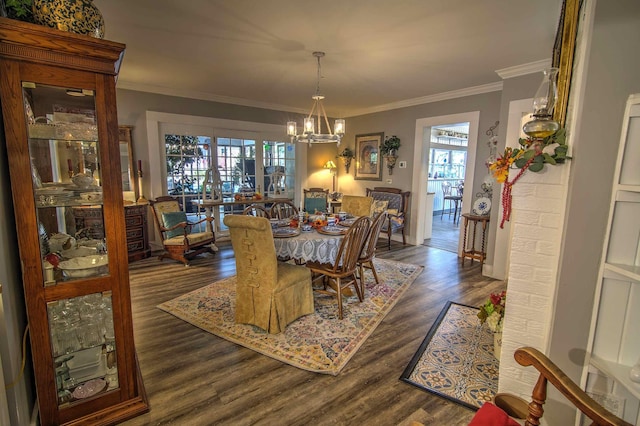 dining area with a notable chandelier, ornamental molding, dark wood-type flooring, and plenty of natural light