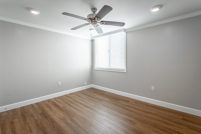 empty room featuring baseboards, wood finished floors, a ceiling fan, and crown molding