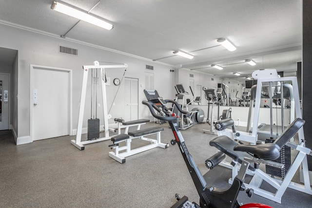 exercise room featuring a textured ceiling, ornamental molding, and visible vents